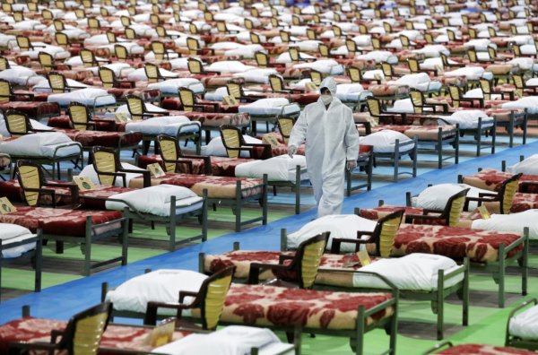 person walks past hundreds of covid patients