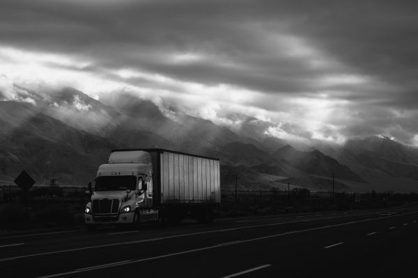 semi truck driving past mountains