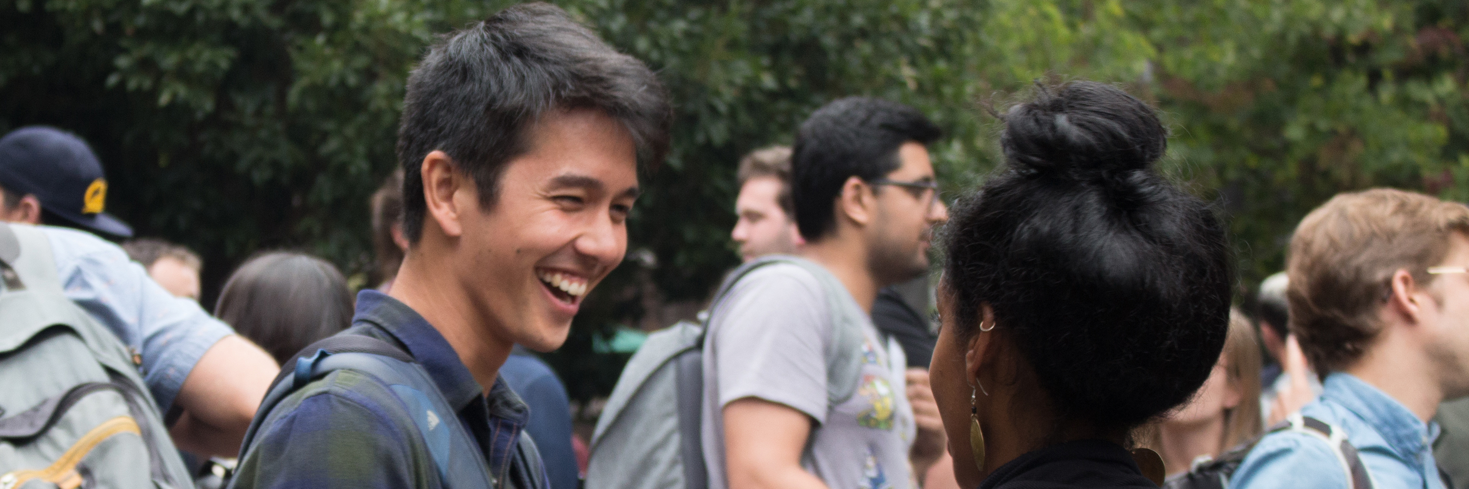 laughing student speaks with another student