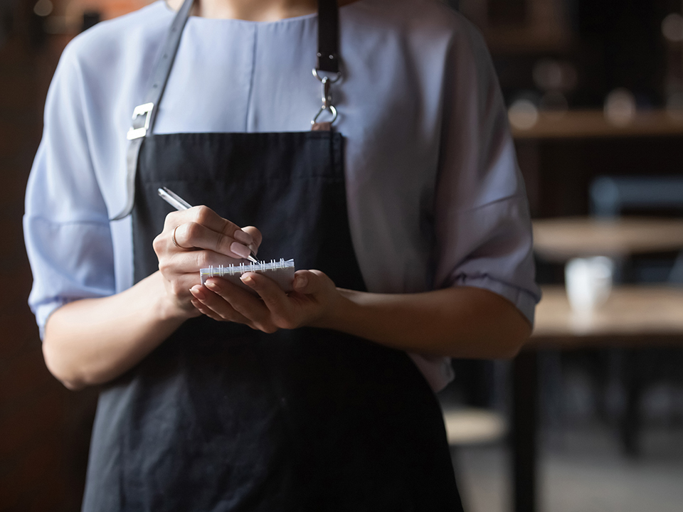 waitress with order pad in her hands