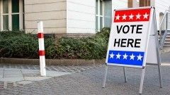 Polling Place Vote Here Sign On White Board Near House